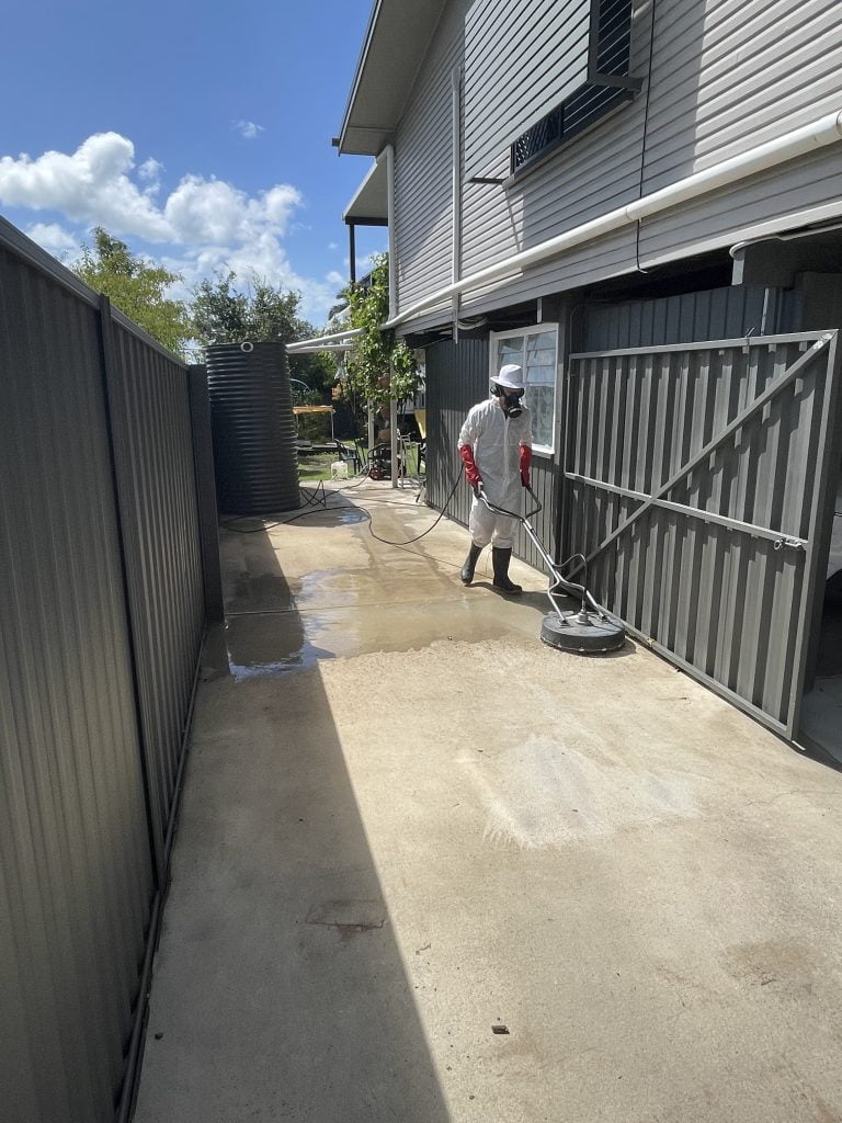 pressure cleaning a driveway with a mask