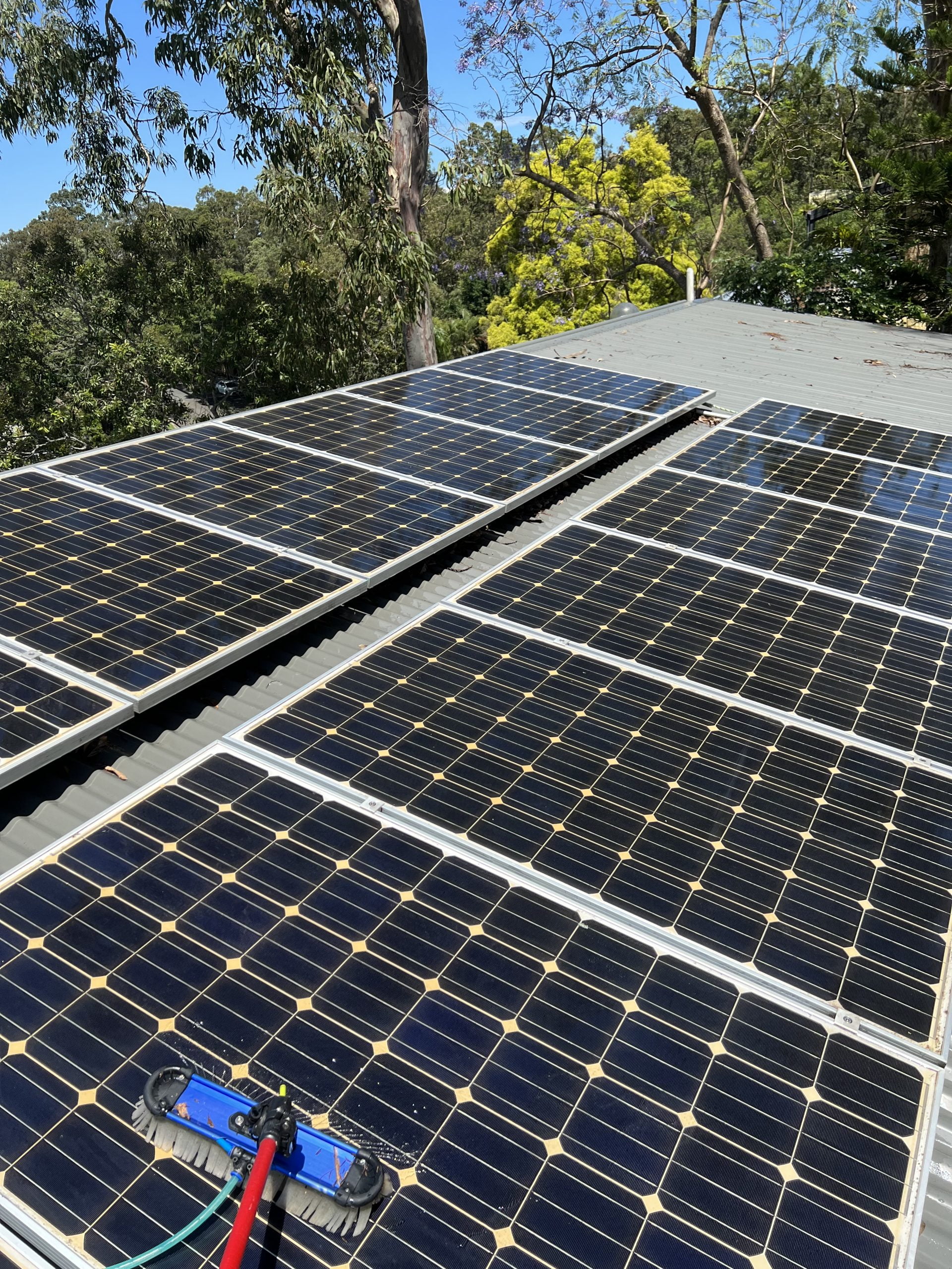 cleaning solar panels using a water-fed pole